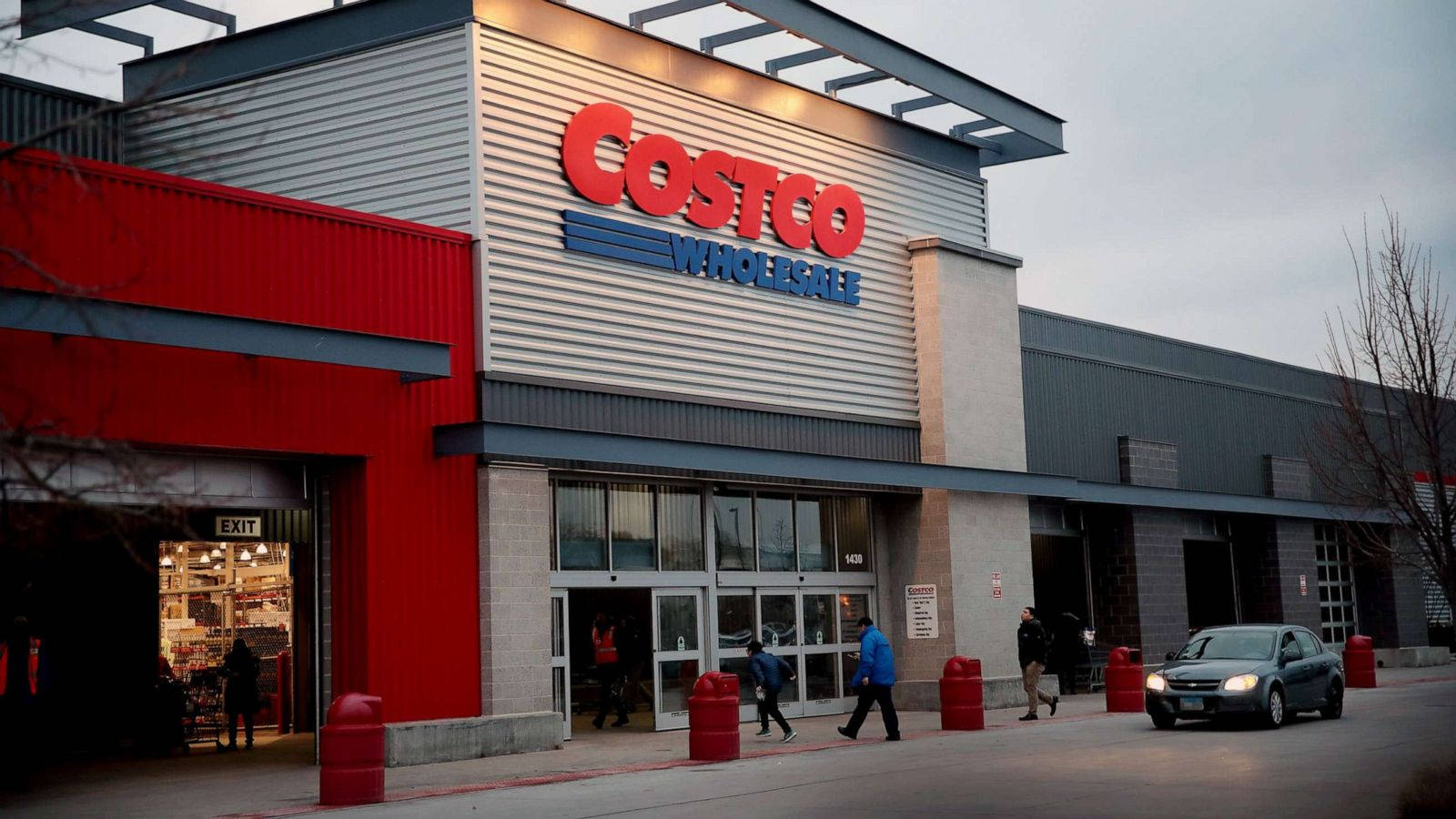 A Bustling Costco Wholesale Store With A Black Car Parked At The Front Wallpaper