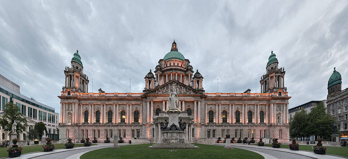 A Large Building With A Clock Tower In The Middle Wallpaper