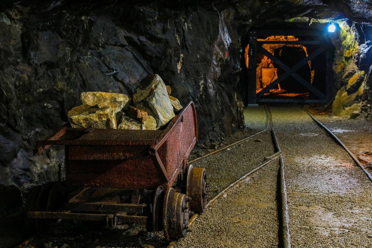 A Mining Cart Full Of Lodes Inside The Goldmines Wallpaper