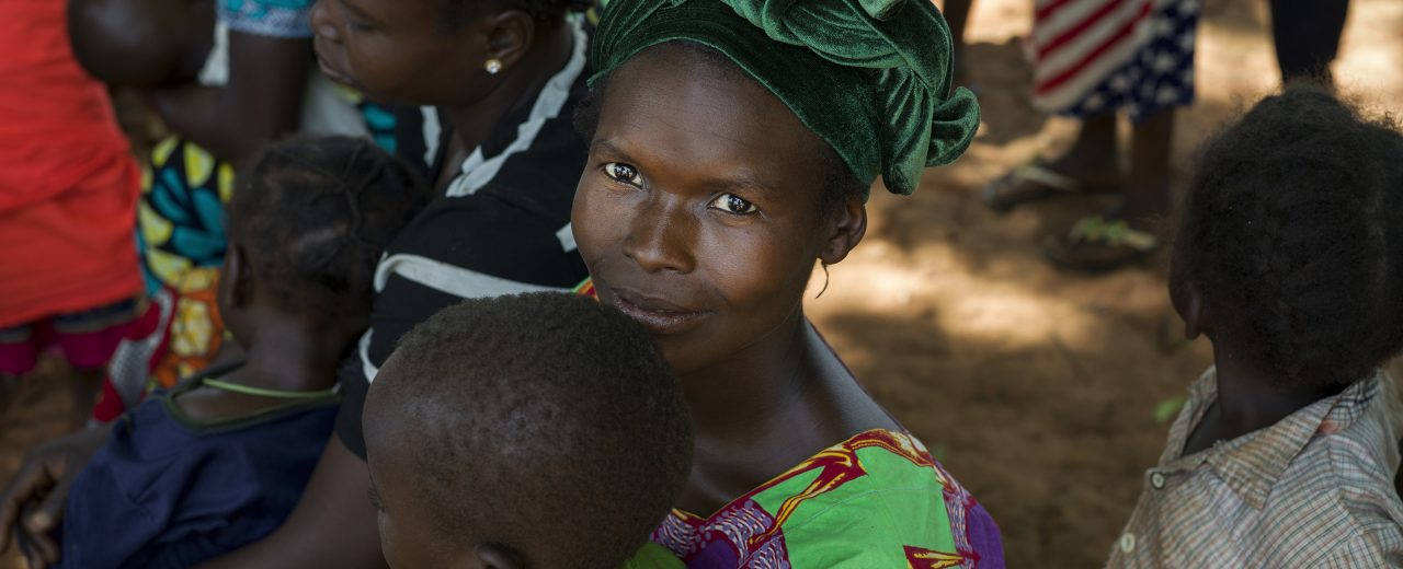 A Mother's Journey - Woman Carrying Her Child In Central African Republic Wallpaper