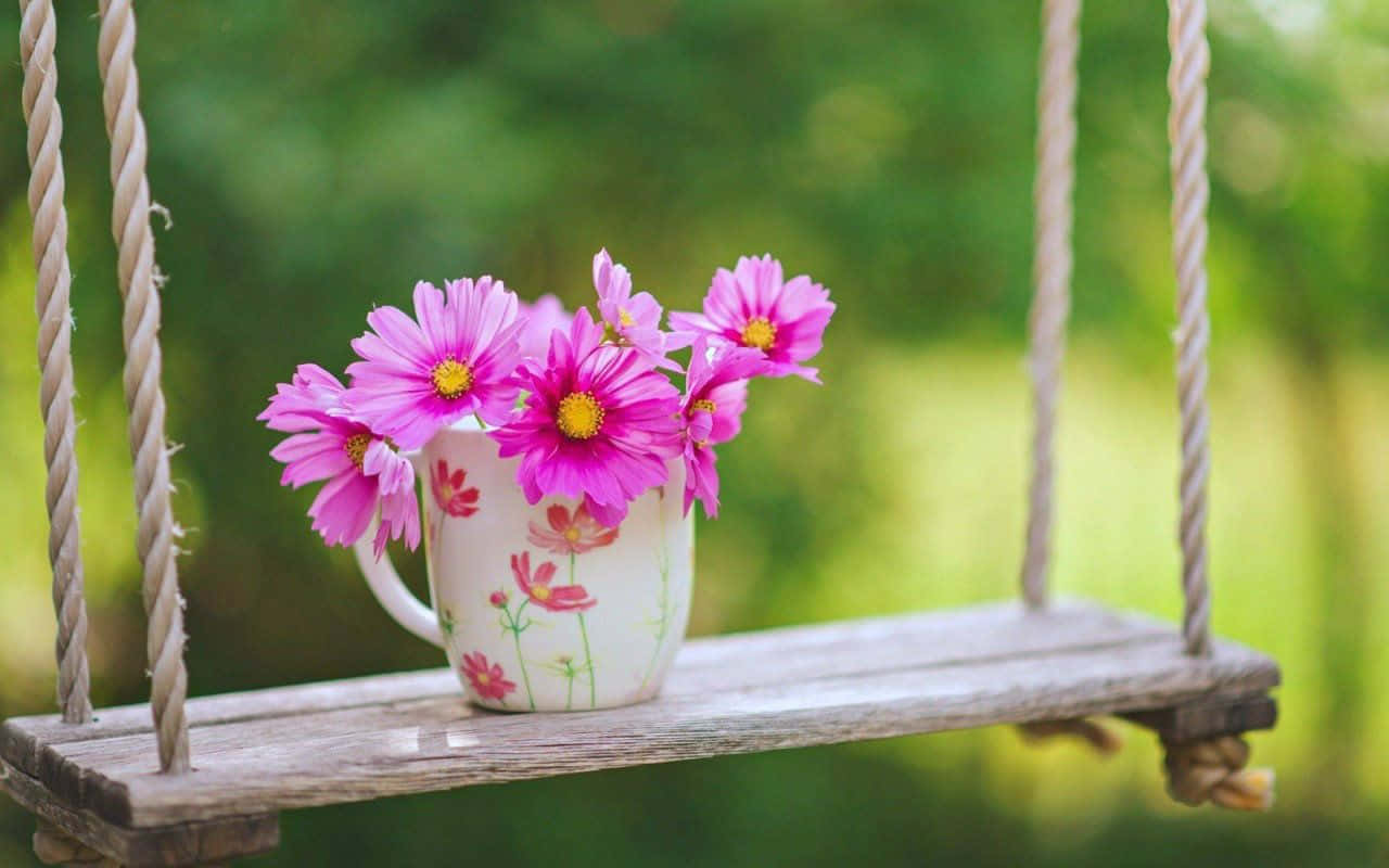 A Swing With Flowers On It Wallpaper