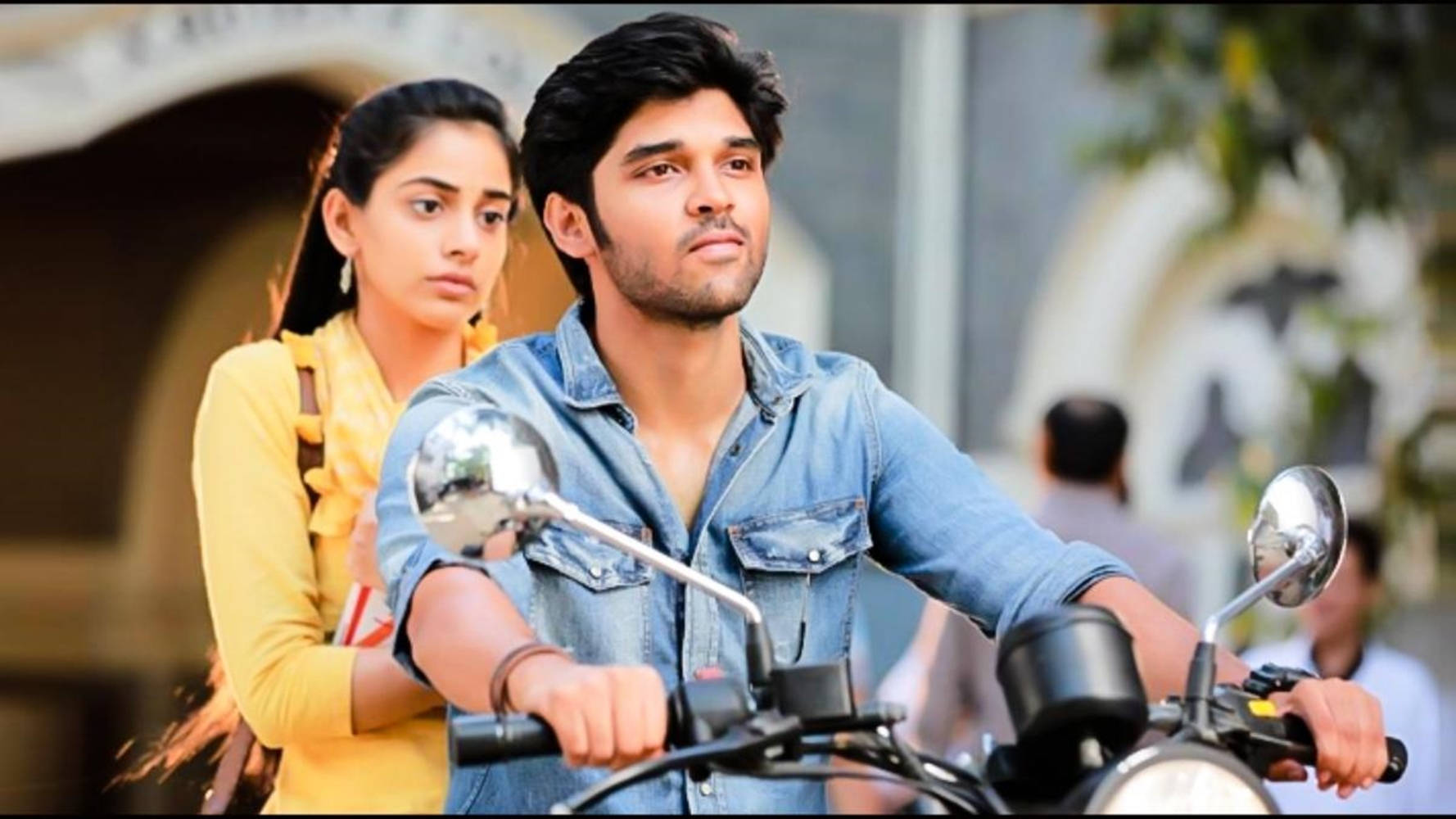 Adithya Varma With Meera Riding A Motorcycle Wallpaper