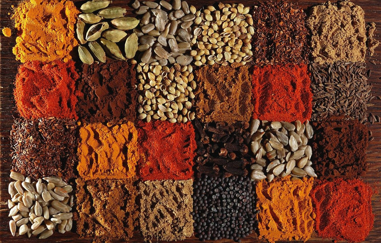 Aesthetically Displayed Collection Of Indian Spices With A Focus On Turmeric Wallpaper