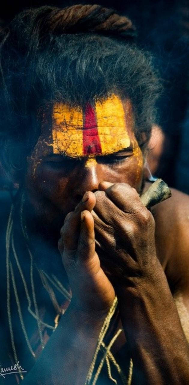 Aghori Lighting Up A Smoke Wallpaper