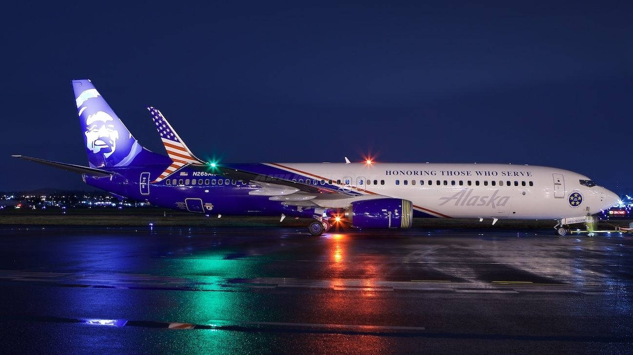 Alaska Airlines' Illuminated Aircraft - A Splash Of Color In The Sky Wallpaper