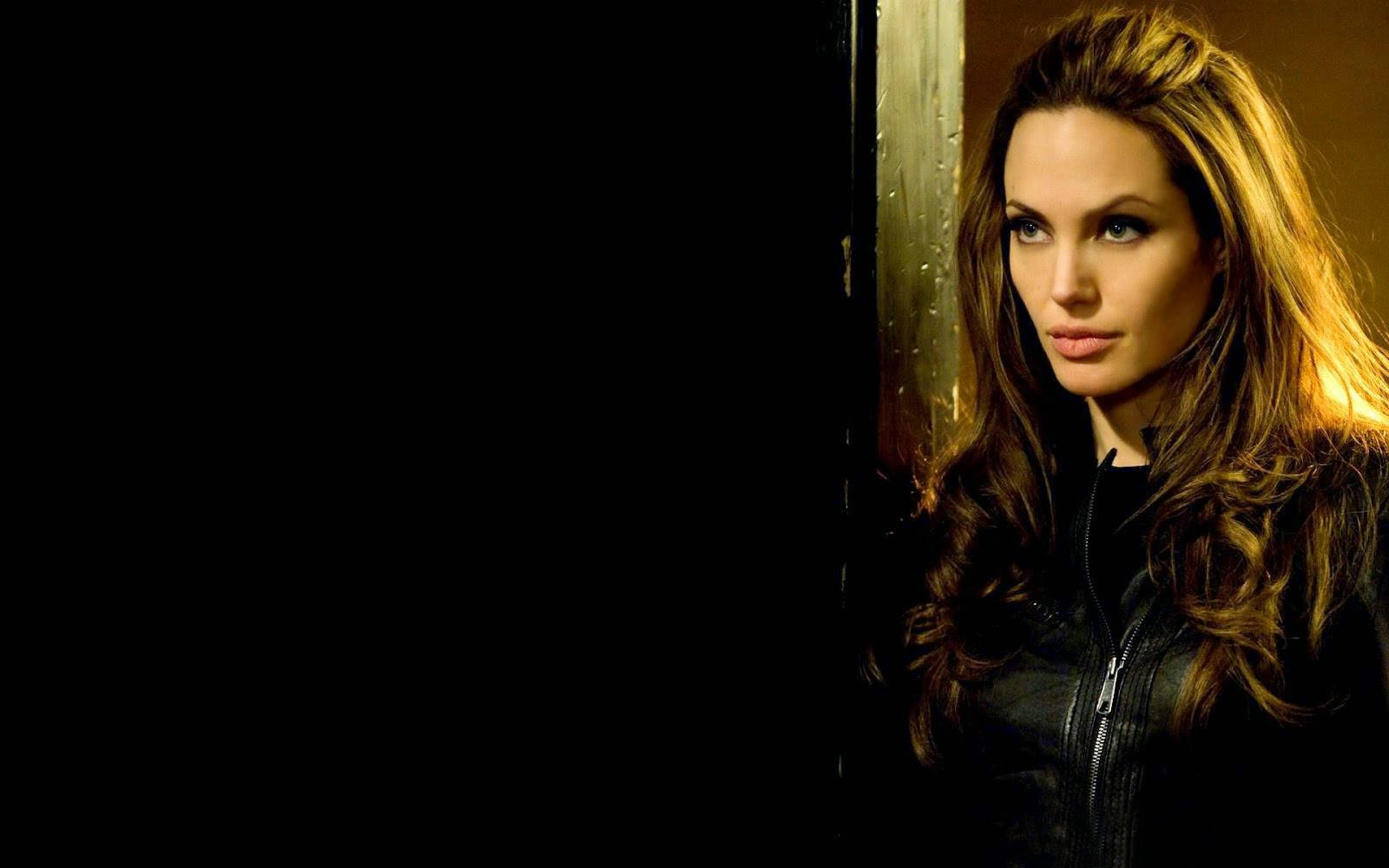 Angelina Jolie Strikes A Powerful Pose In All-black Leather. Wallpaper