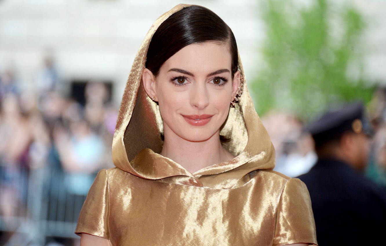 Anne Hathaway In A Glamorous Golden Robe Wallpaper