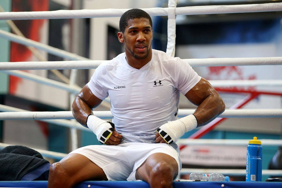 Anthony Joshua Posing In A White Shirt Wallpaper