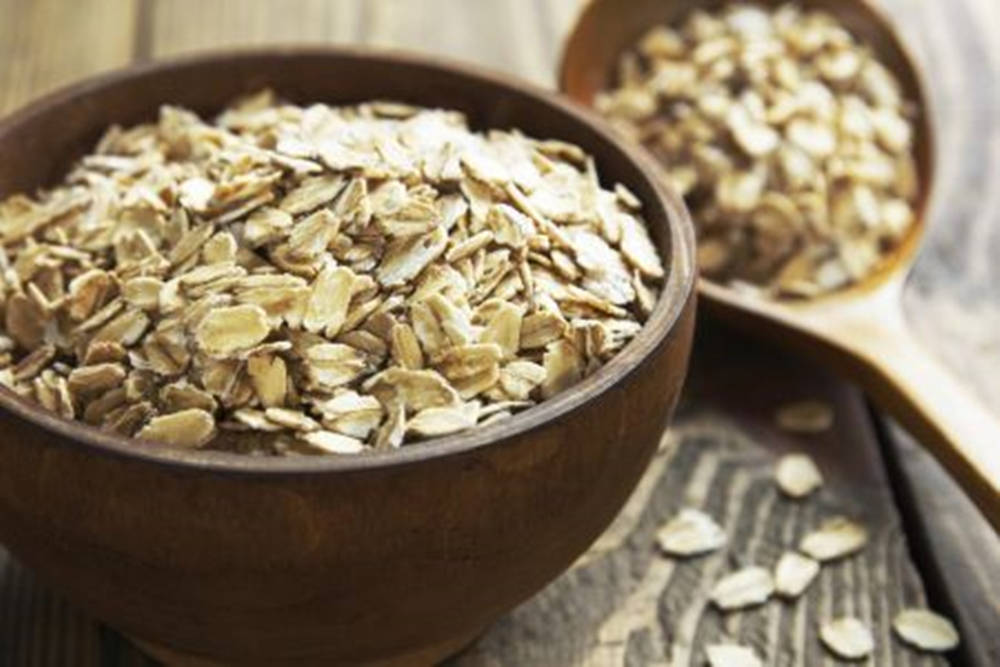 Artisanal Wooden Bowl With Raw Oatmeal Wallpaper