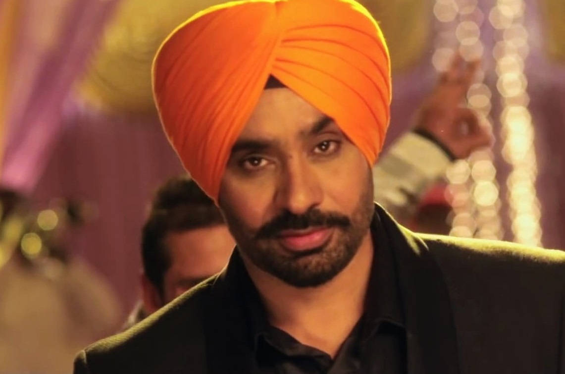 Babbu Maan Wearing An Orange Turban Wallpaper