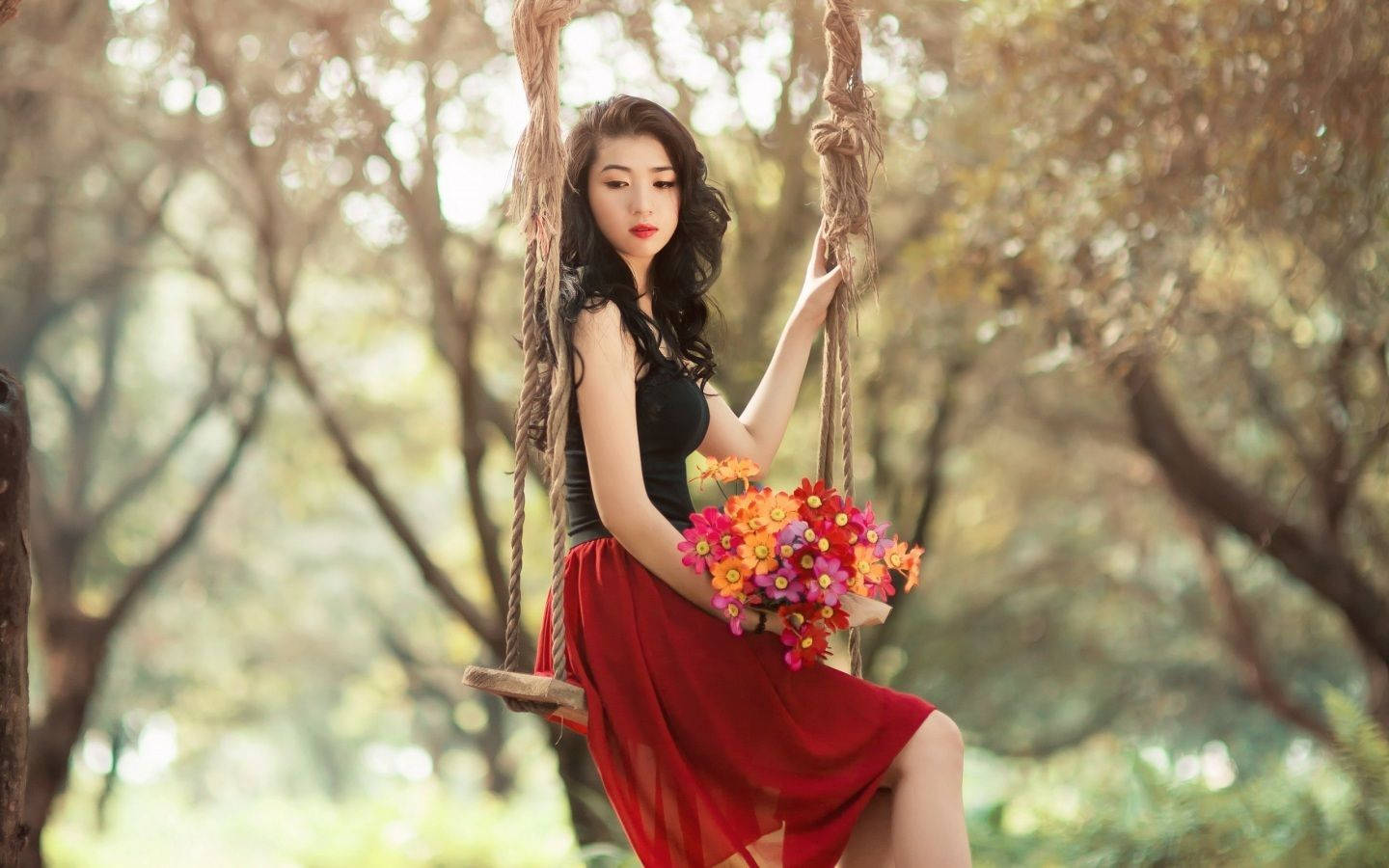 Beautiful Girl Posing On A Swing Wallpaper