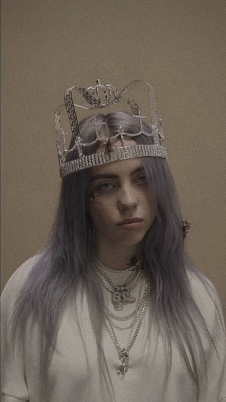 Billie Eilish Looking Up With A Wistful Expression Wallpaper