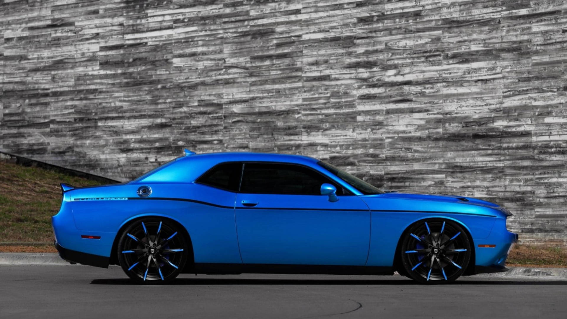 Blue Dodge Challenger Beside A Gray Wall Wallpaper