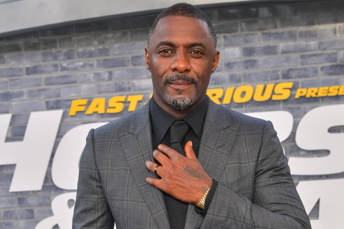 British Actor Idris Elba Stylishly Adjusting His Tie Wallpaper