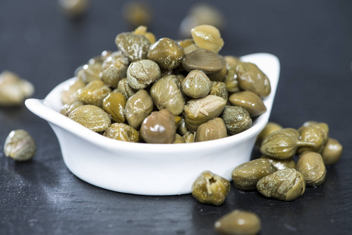 Capers In A White Ceramic Bowl Wallpaper