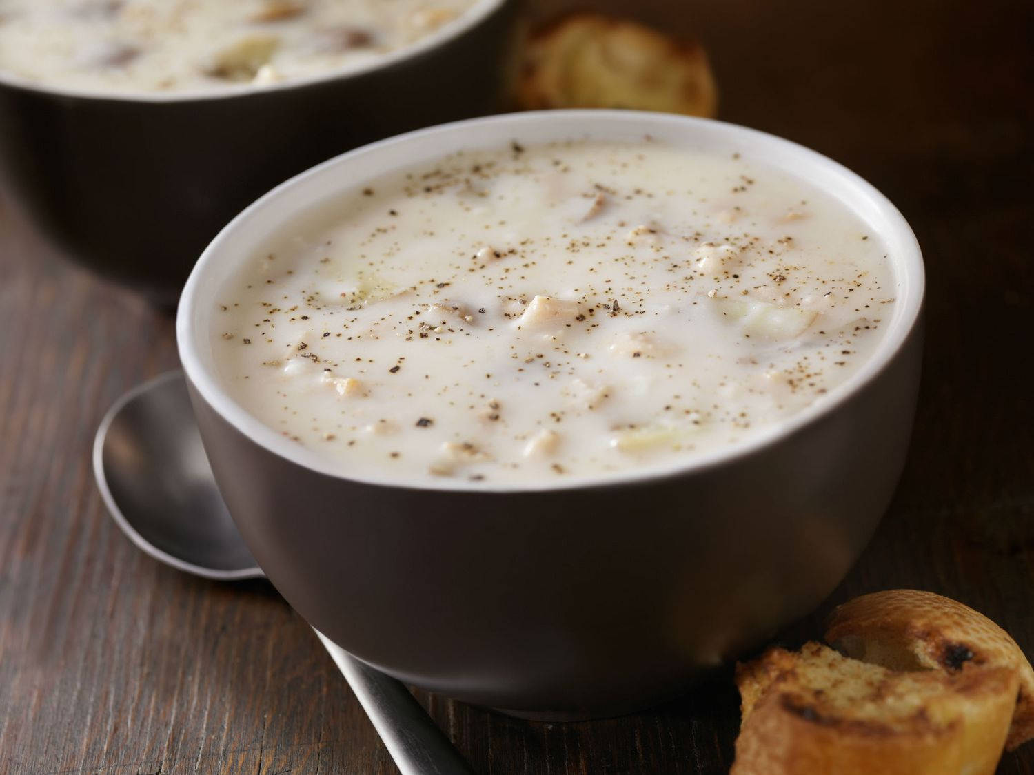 Caption: A Warm Bowl Of New England Clam Chowder With Toasted Bread Wallpaper