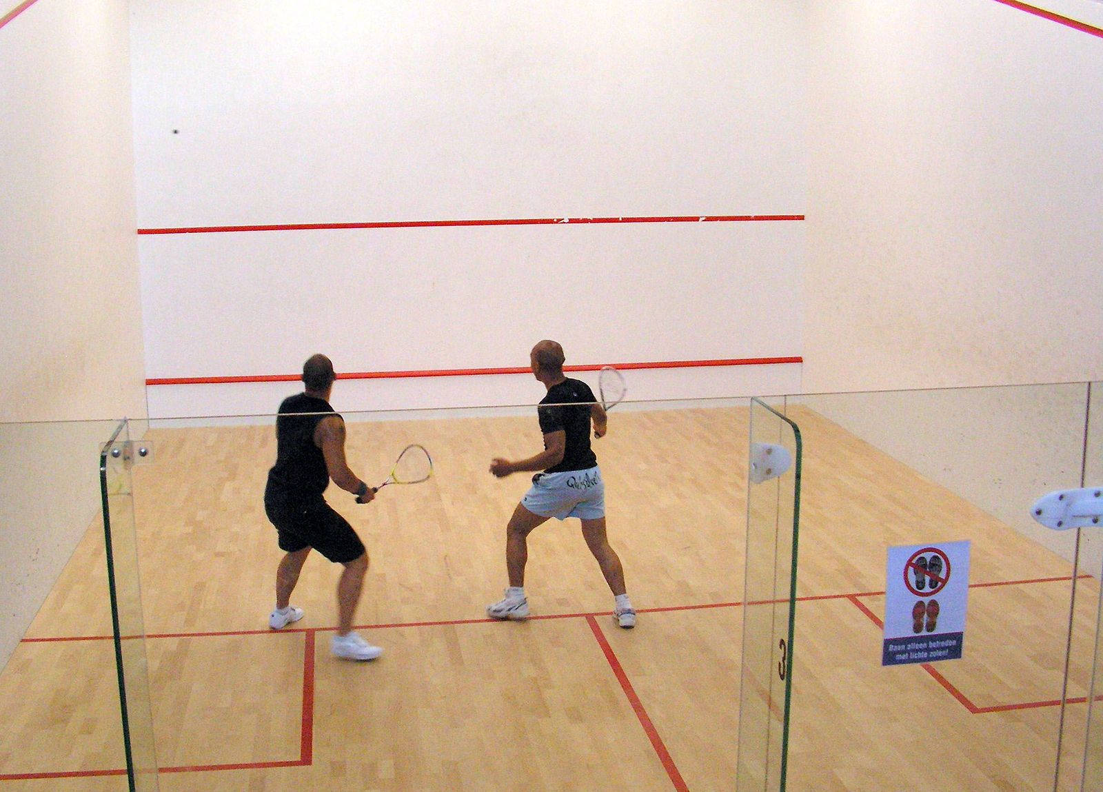 Caption: Intense Racquetball Match In Action Wallpaper