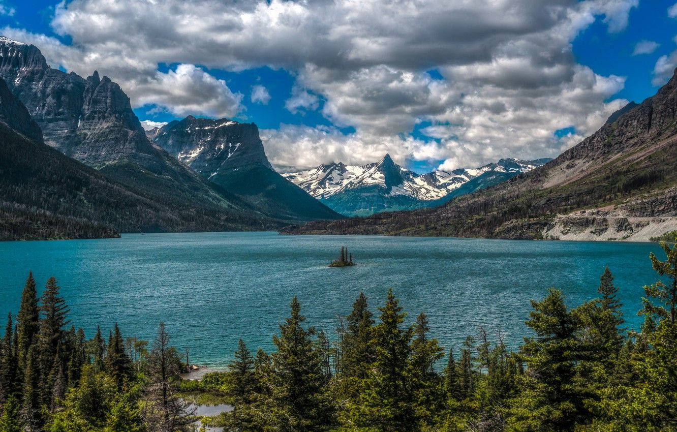 Caption: Spectacular View Of The Blue Lake At Glacier National Park Wallpaper