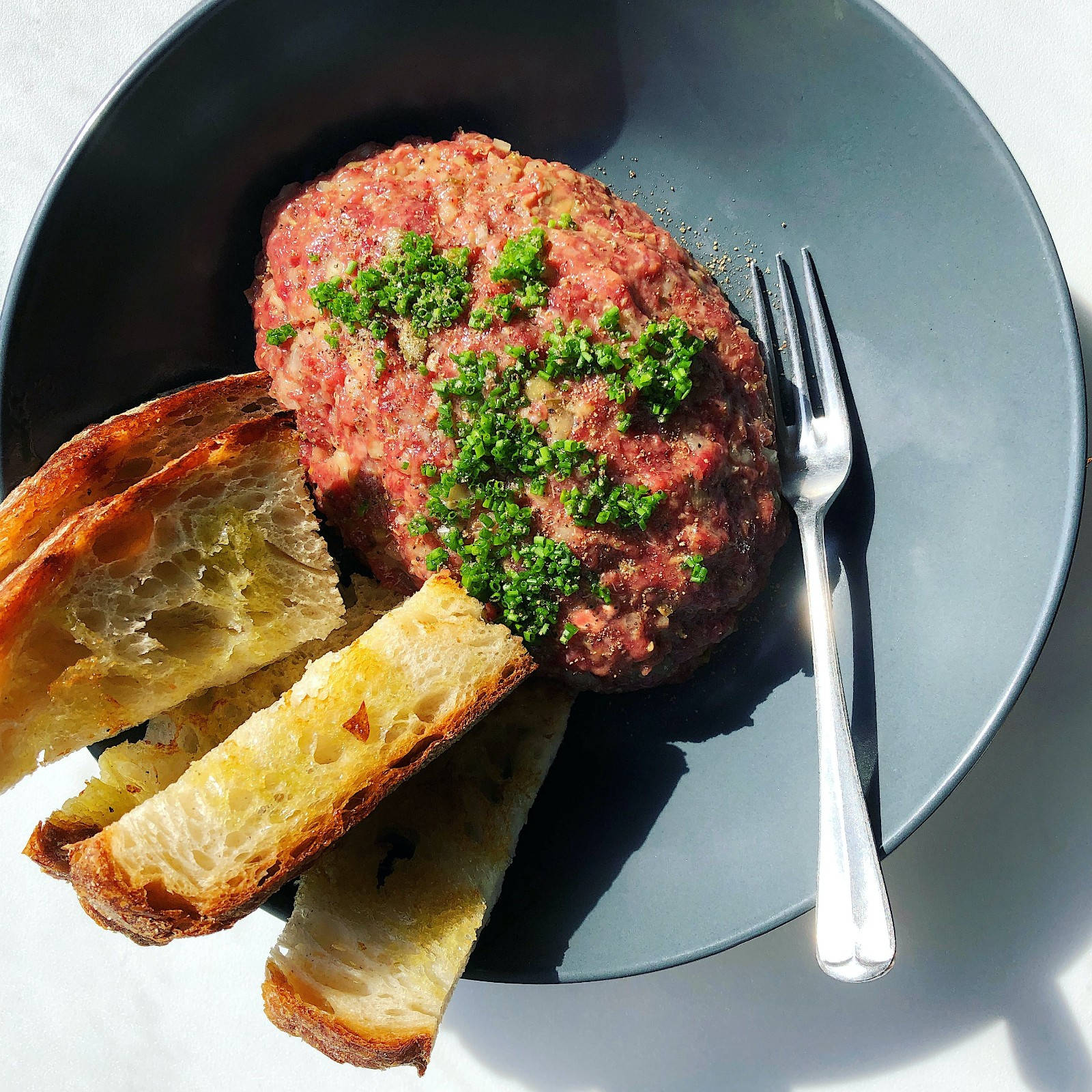 Caption: Succulent Steak Tartare Served With Bread Wallpaper