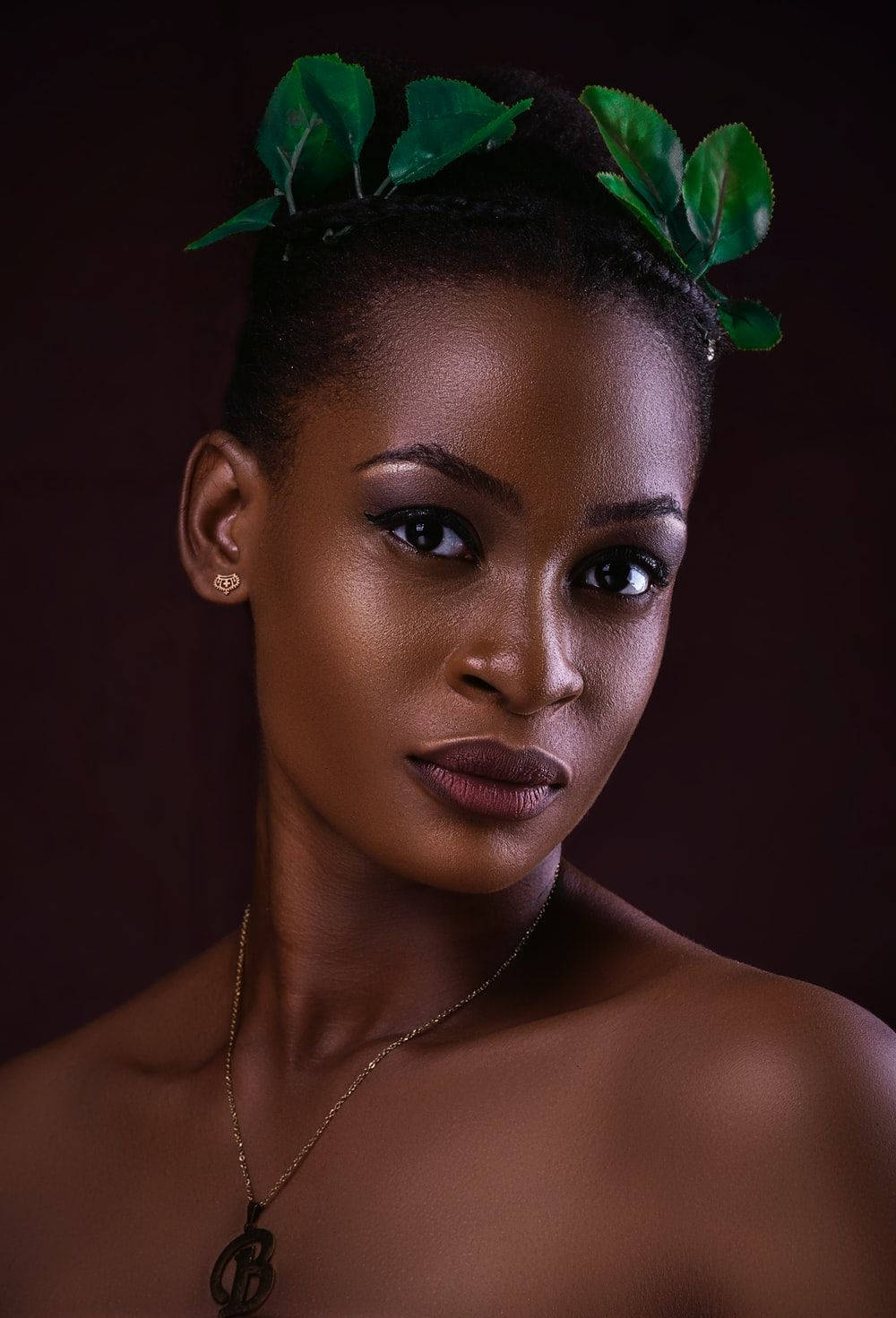 Captivating Portrait Of Beautiful Black Woman In Leaf Headdress Wallpaper