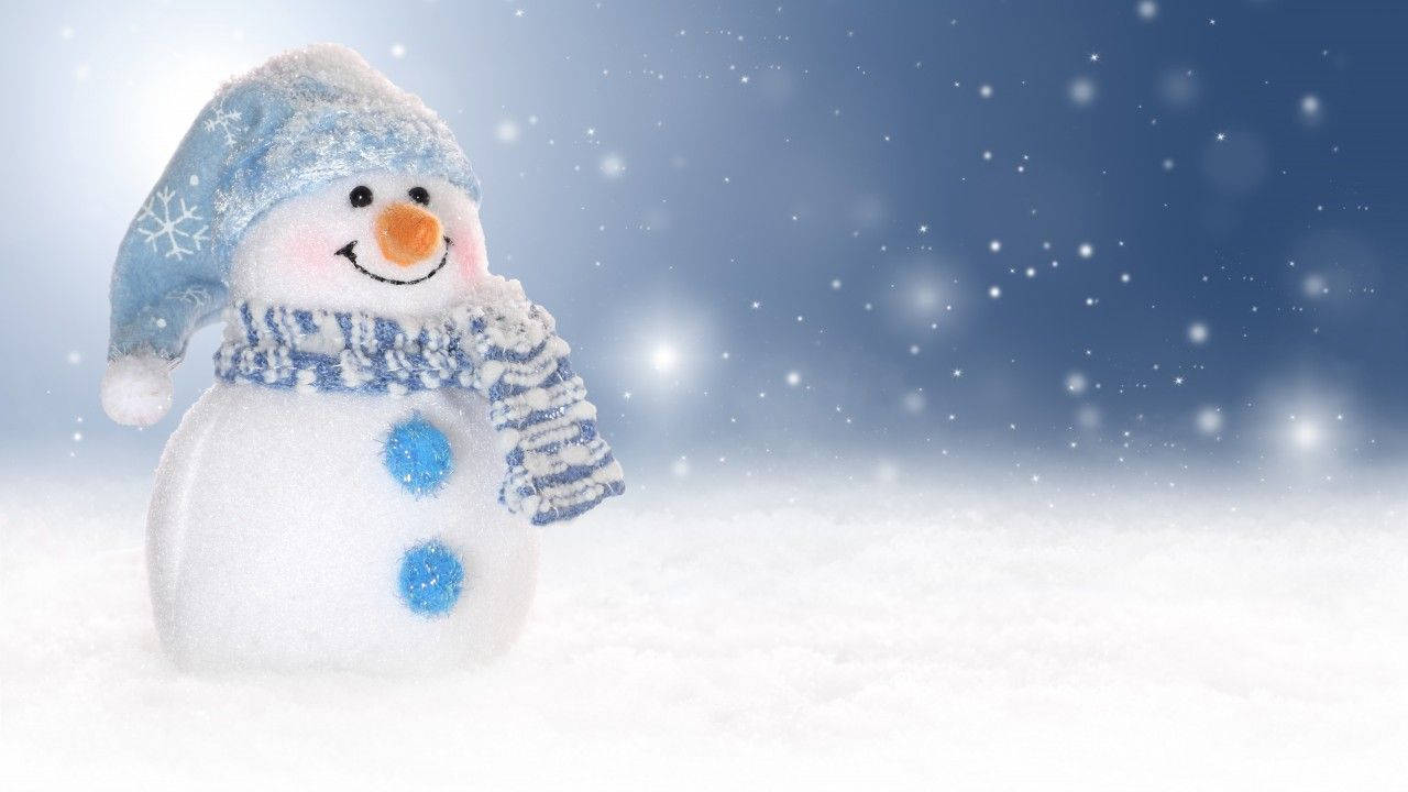 Celebrate Winter With A Cheerful Snowman In The Snow! Wallpaper