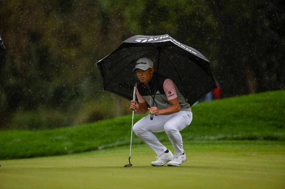 Collin Morikawa Under An Umbrella Wallpaper