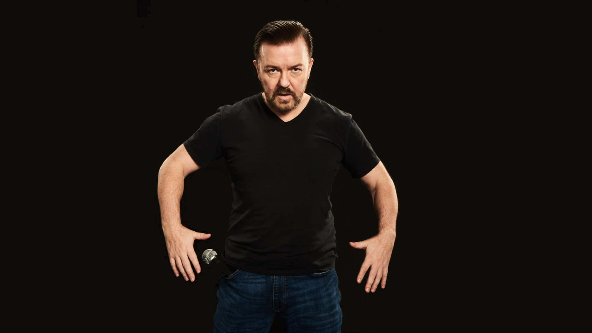 Comedian Ricky Gervais Laughing At A Comedy Event Wallpaper