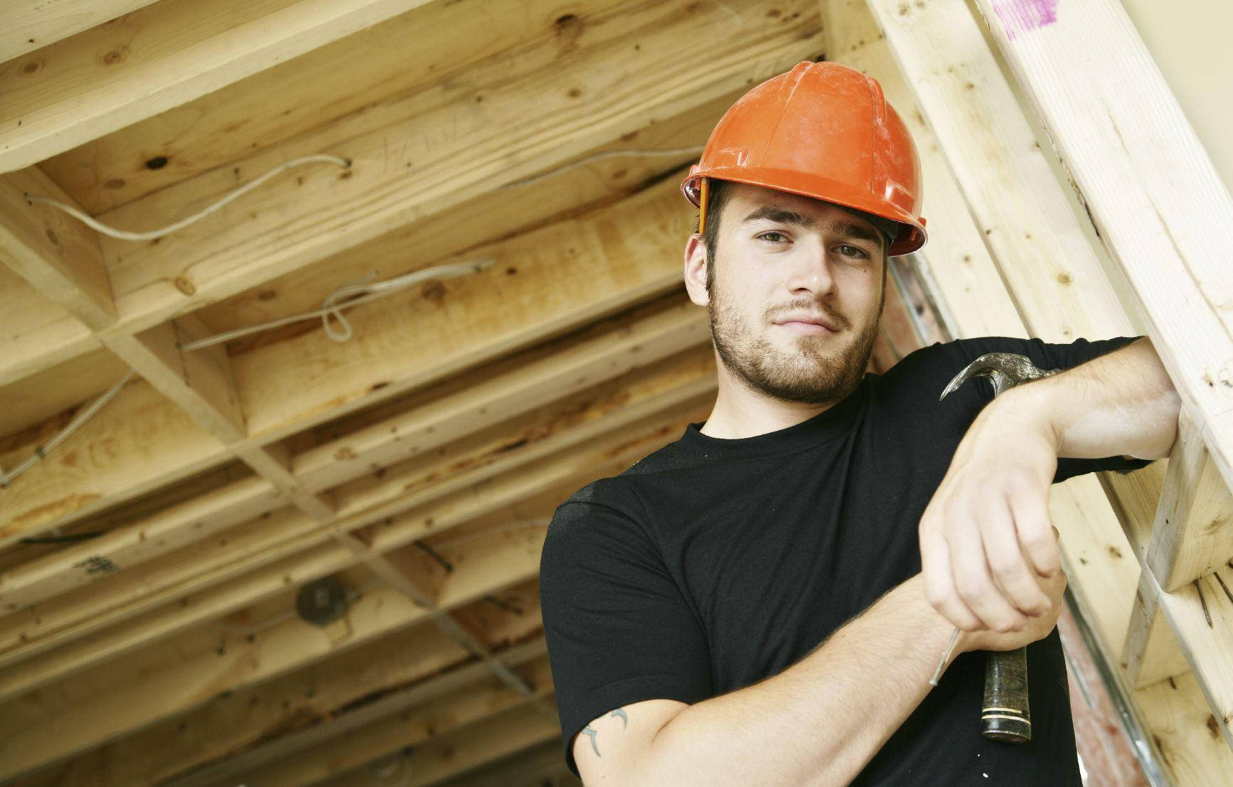 Construction Worker Smiling At Tthe Camera Wallpaper