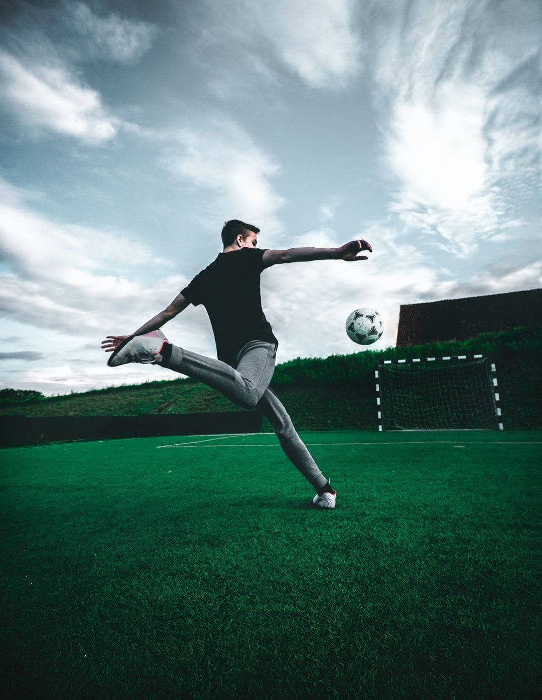 Cool Pfp Football Player Kicking Ball Wallpaper