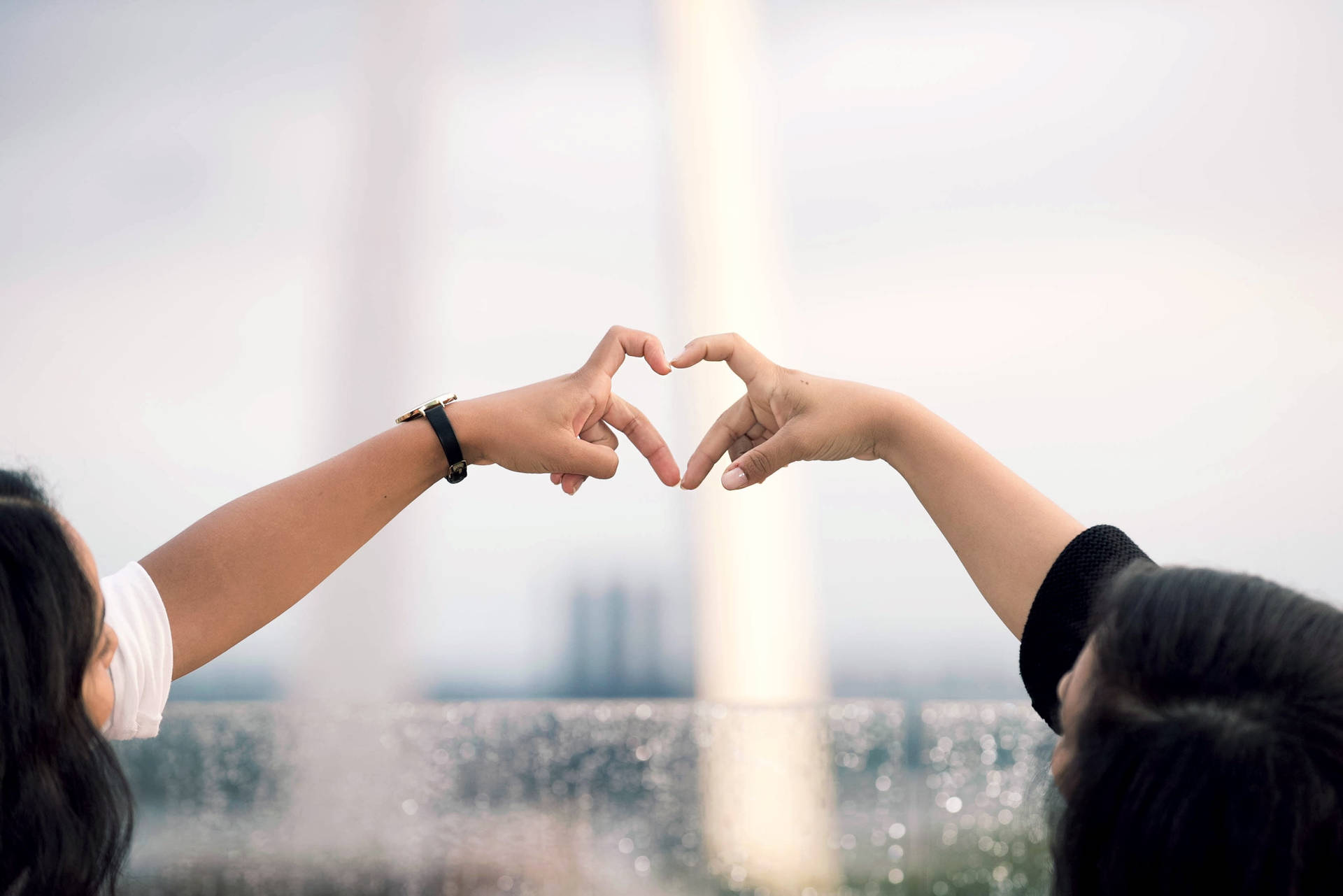 Couple Doing Finger Heart Trend Wallpaper