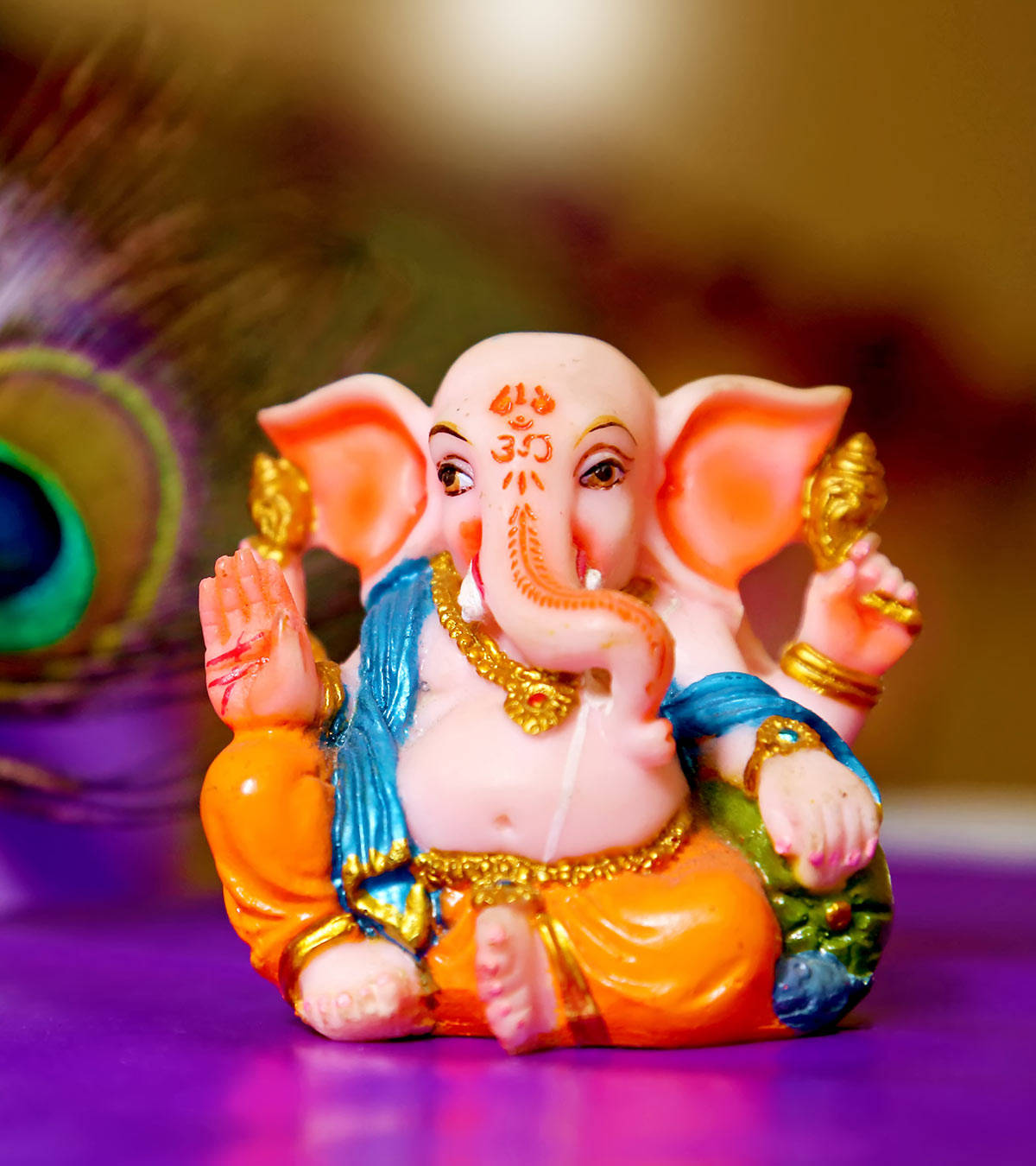 Cute Ganesha On Purple Table Wallpaper