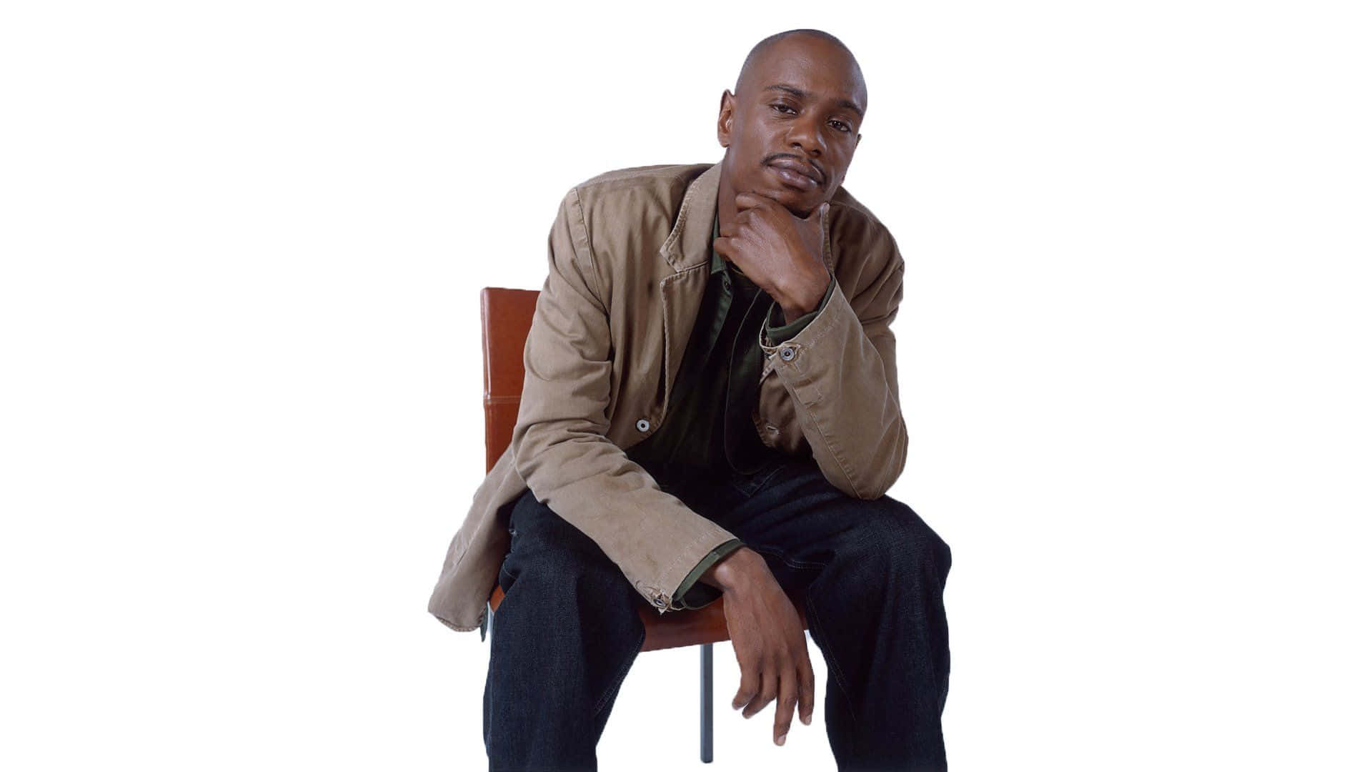Dave Chappelle Onstage Delivering An Impactful Comedy Performance Wallpaper