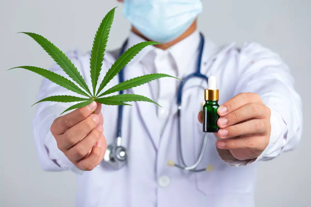 Doctor Holding Weed Leaf And Bottle Wallpaper