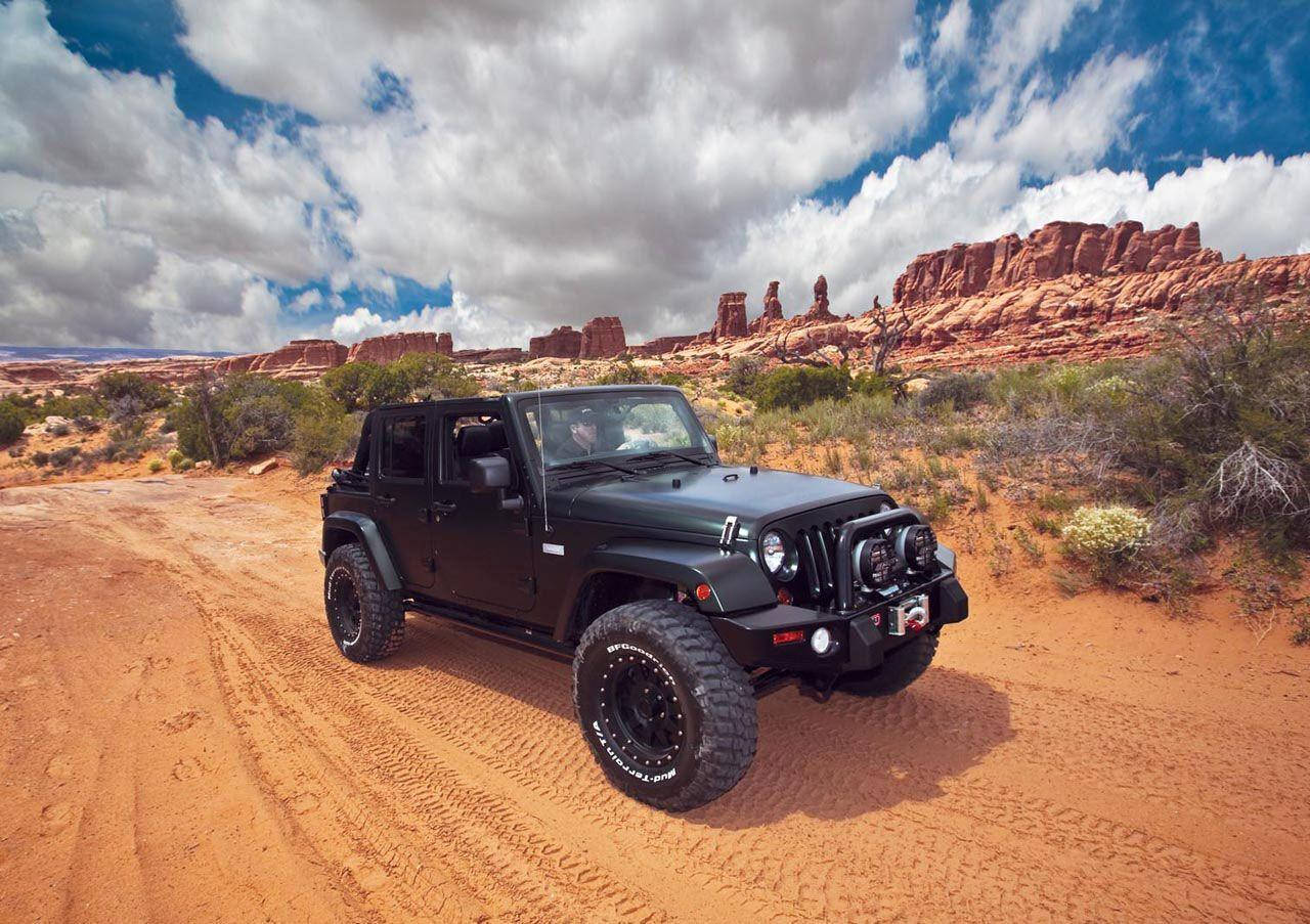 Elegant Black Jeep Wrangler Navigating The Wild Savanna. Wallpaper