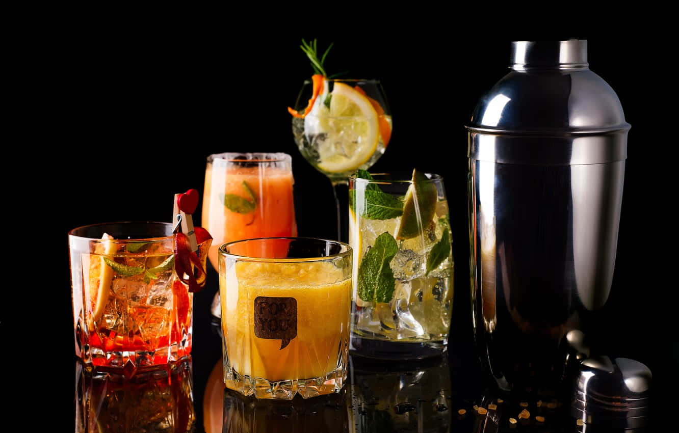 Elegant Cocktail Drinks Illuminated On Dark Background Wallpaper