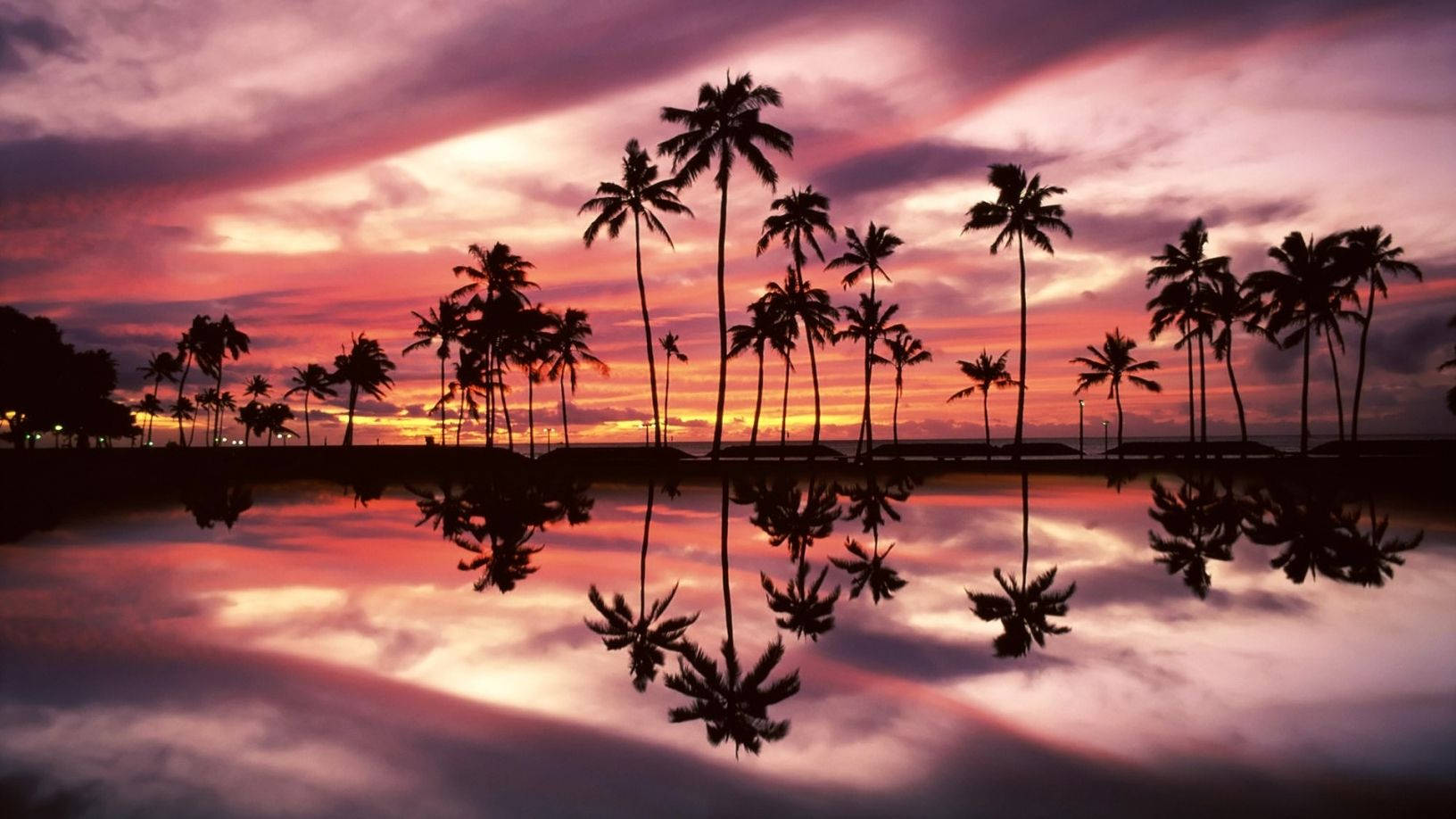 Enjoy The Peaceful Beauty Of A Sunset On The Beach With Your Macbook Wallpaper