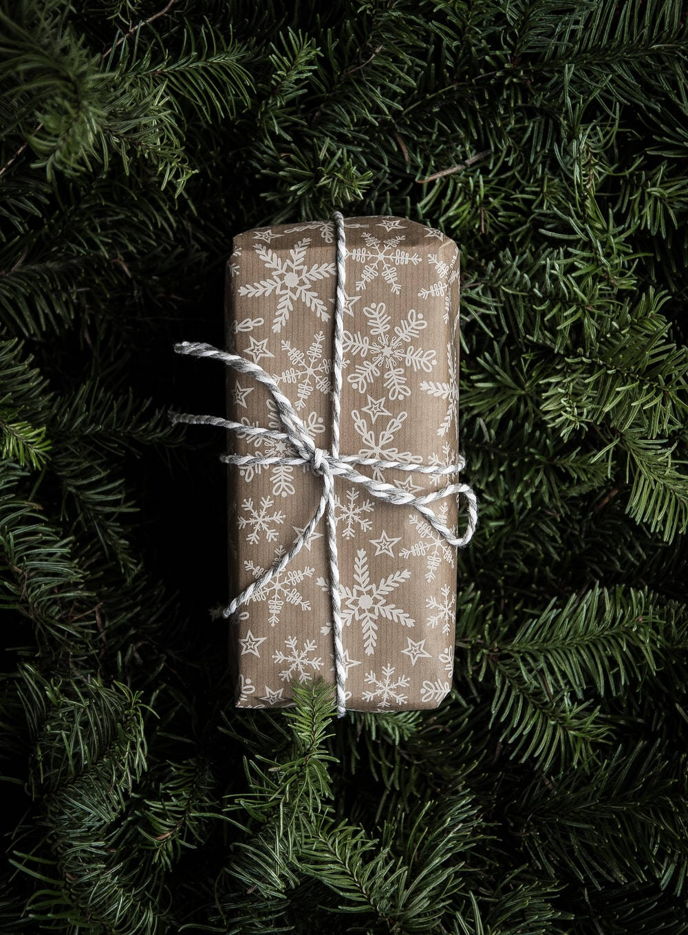 Festive Christmas Gift Wrapped In Brown And White Wallpaper