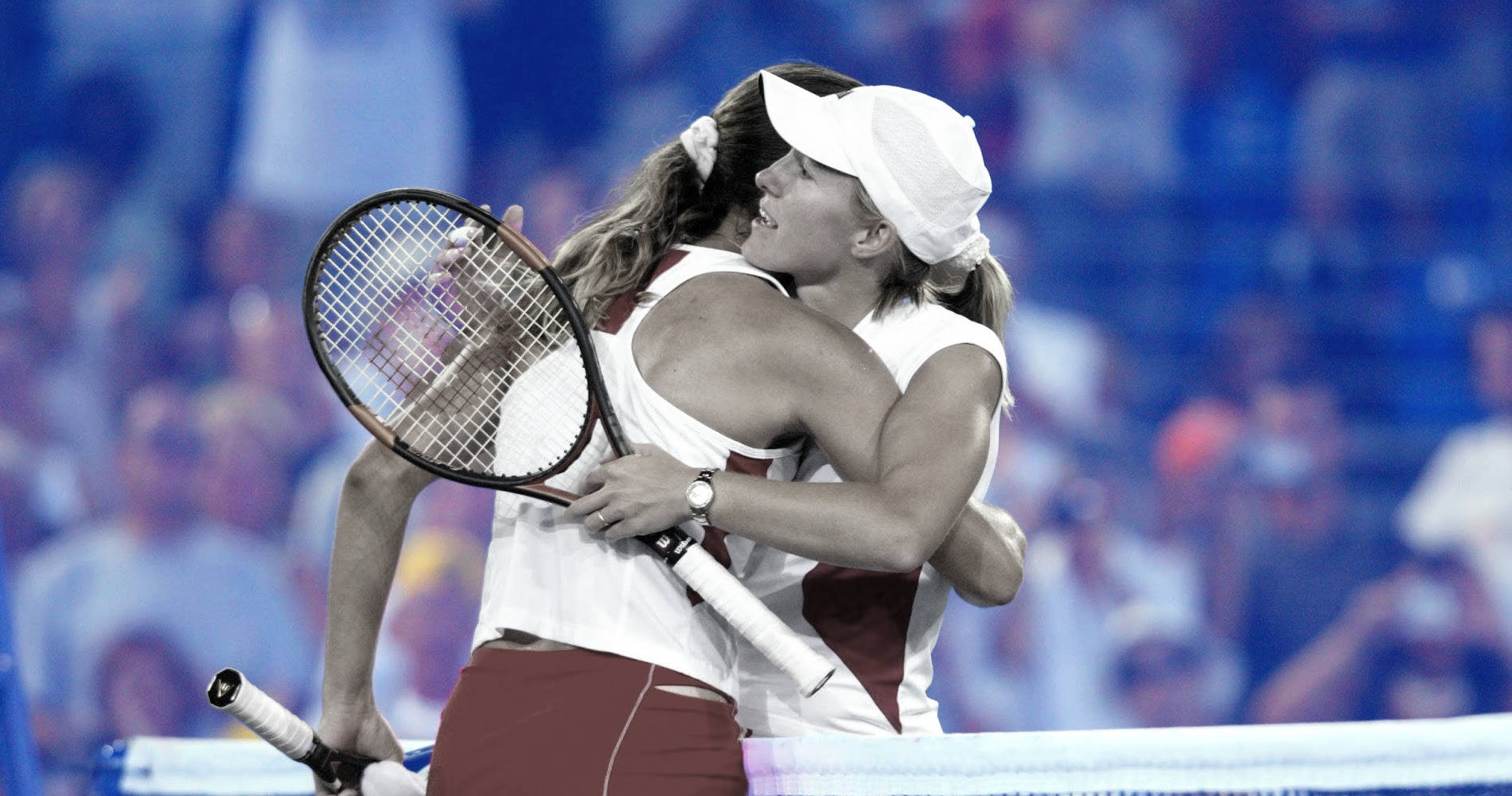 French Tennis Player Amélie Mauresmo And Belgian Star Justine Henin Disputing A Point During A Tennis Match Wallpaper