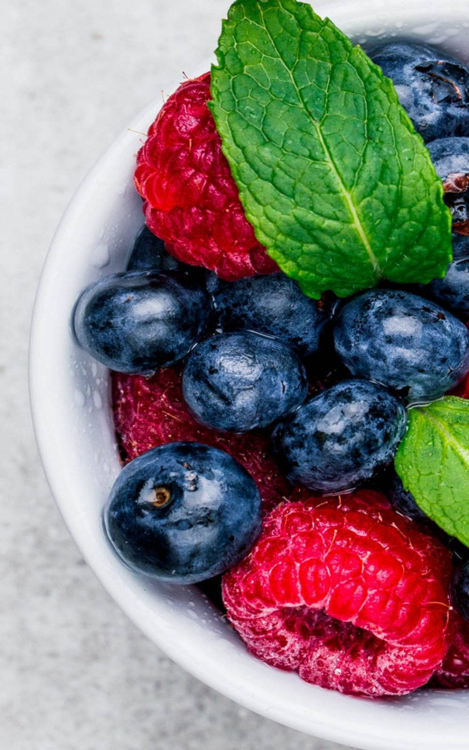 Fresh Blueberries And Raspberries In A Ceramic Bowl Wallpaper