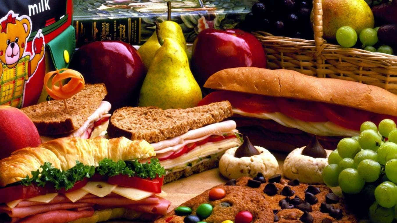 Freshly Prepared Delicious Sandwiches Paired With Refreshing Fruits And Tantalizing Cookies Wallpaper