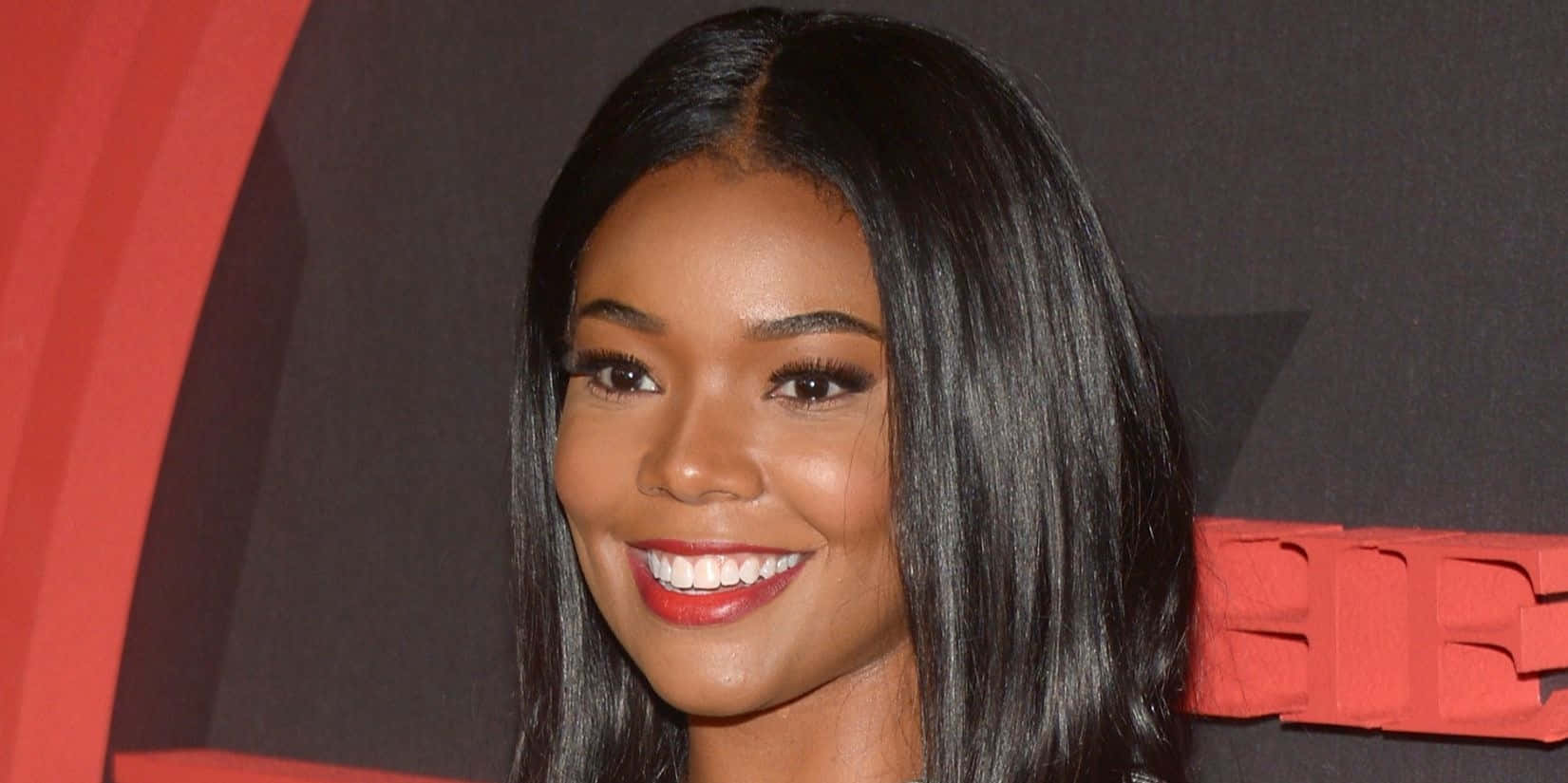 Gabrielle Union Smiling Radiantly In White Outfit Wallpaper