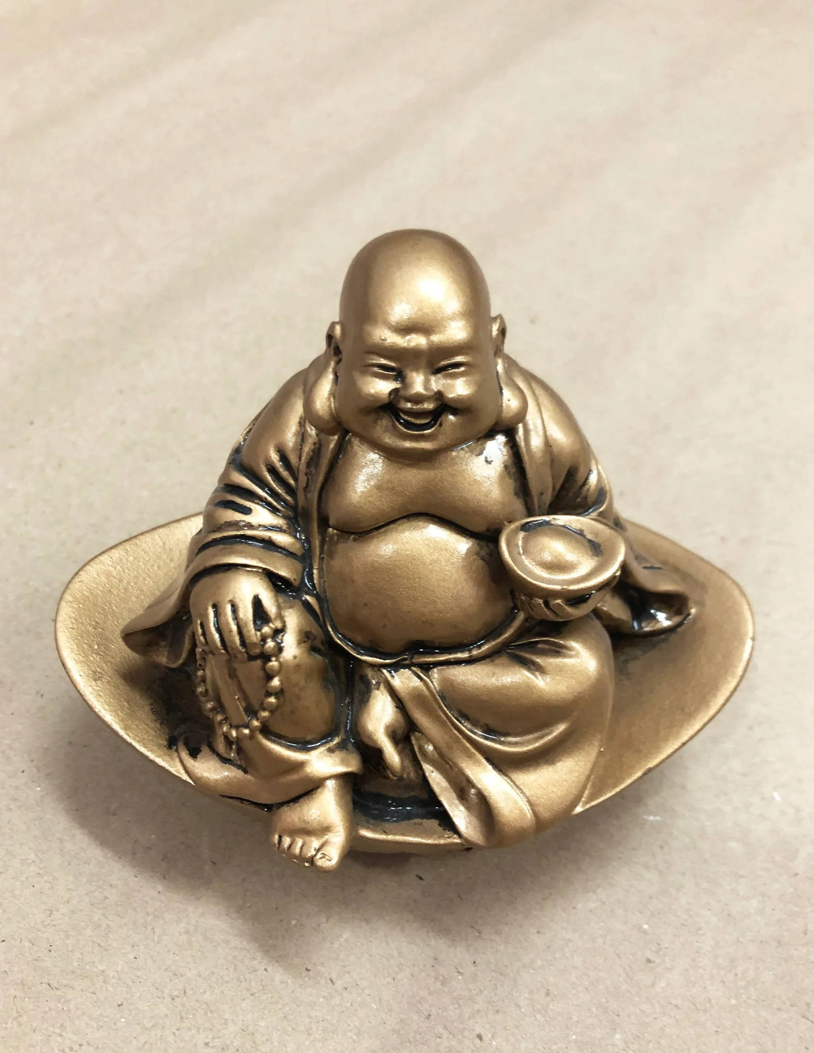 Gleaming Small Laughing Buddha Statue Wallpaper