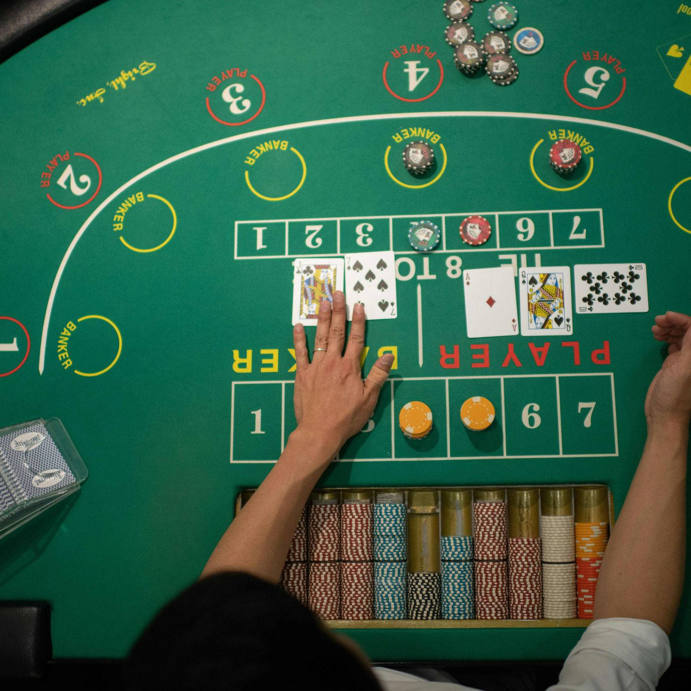 Hand Of The Dealer In A Baccarat Game Wallpaper