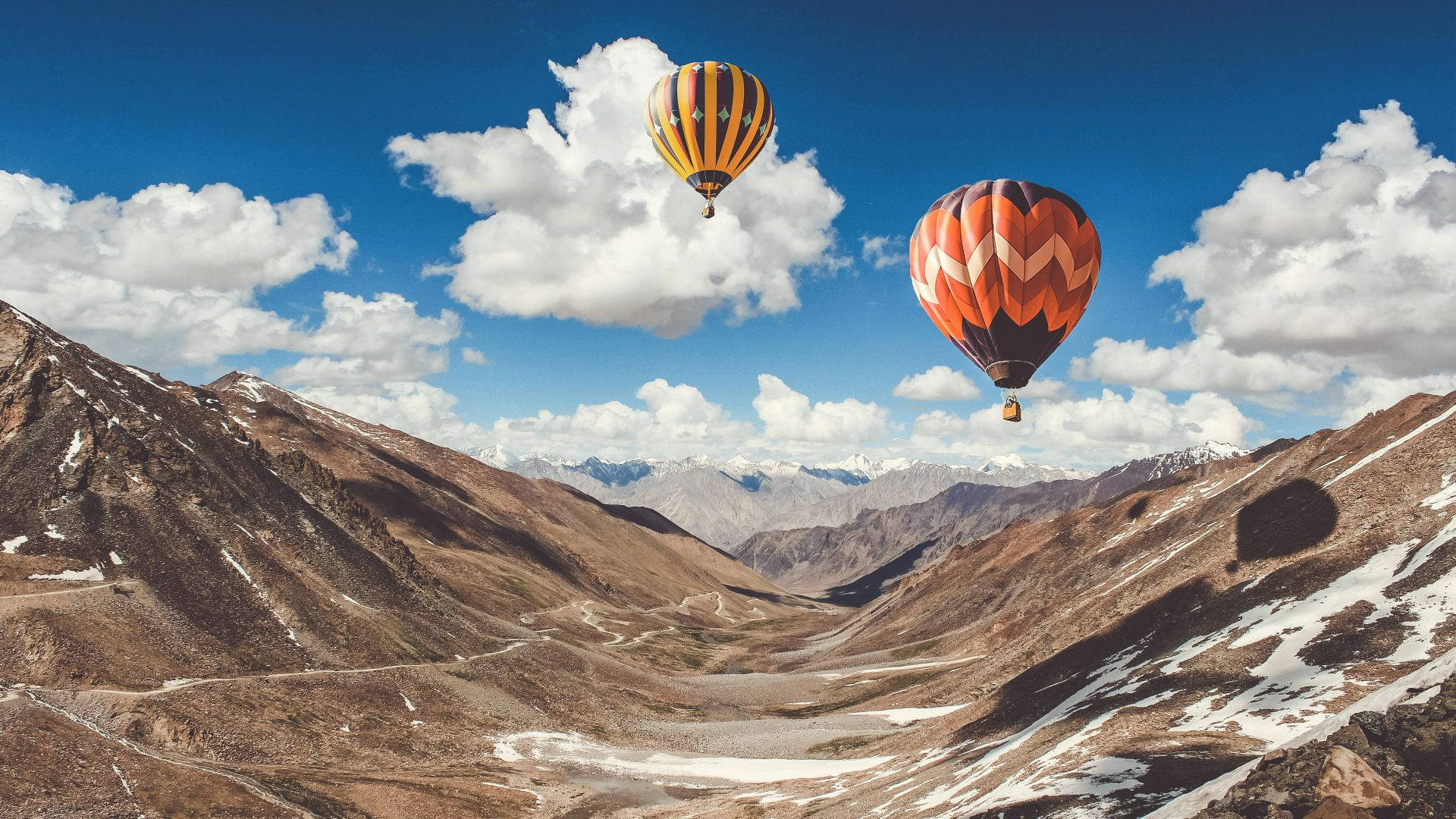 Hot Air Balloon Above A Valley Wallpaper