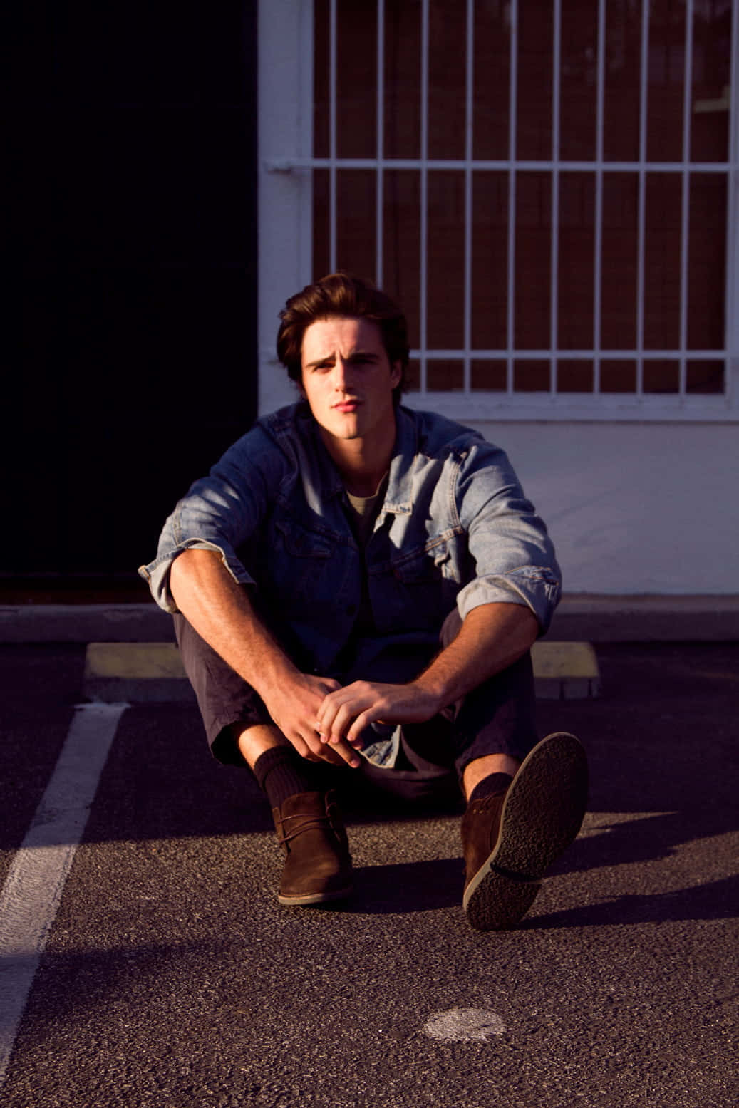 Jacob Elordi Stares Into The Camera While Sitting In A Director's Chair. Wallpaper