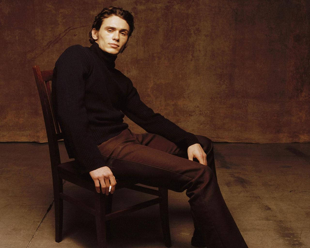 James Franco Wearing A Black Turtleneck In A Brown Room Wallpaper