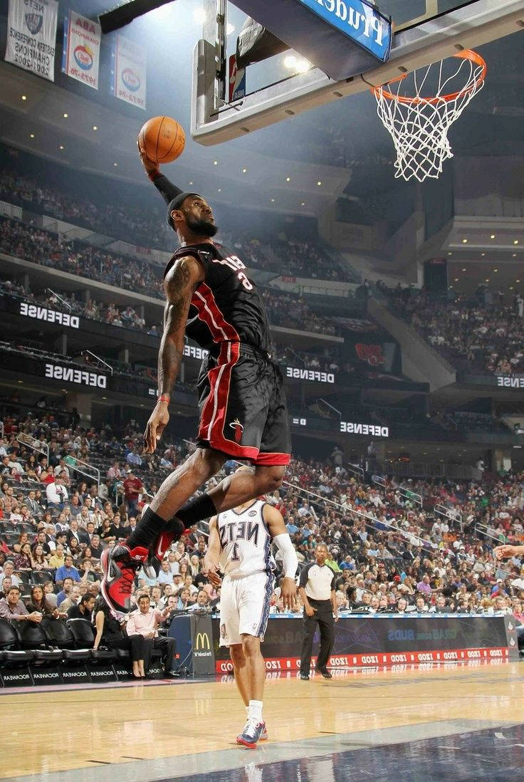 Lebron James Soaring High Through The Air On An Epic Slam Dunk Wallpaper