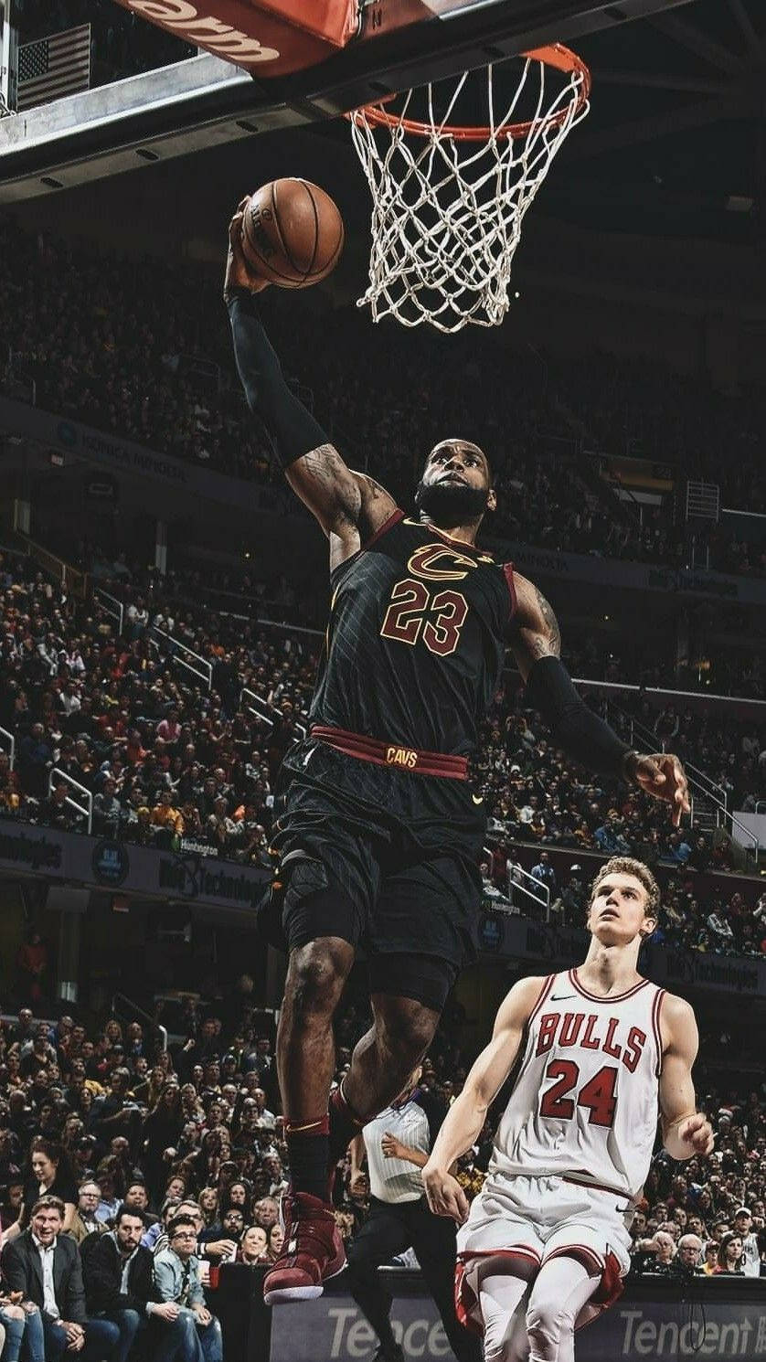 Lebron James Stuns Crowd With A Spectacular Slam Dunk Wallpaper