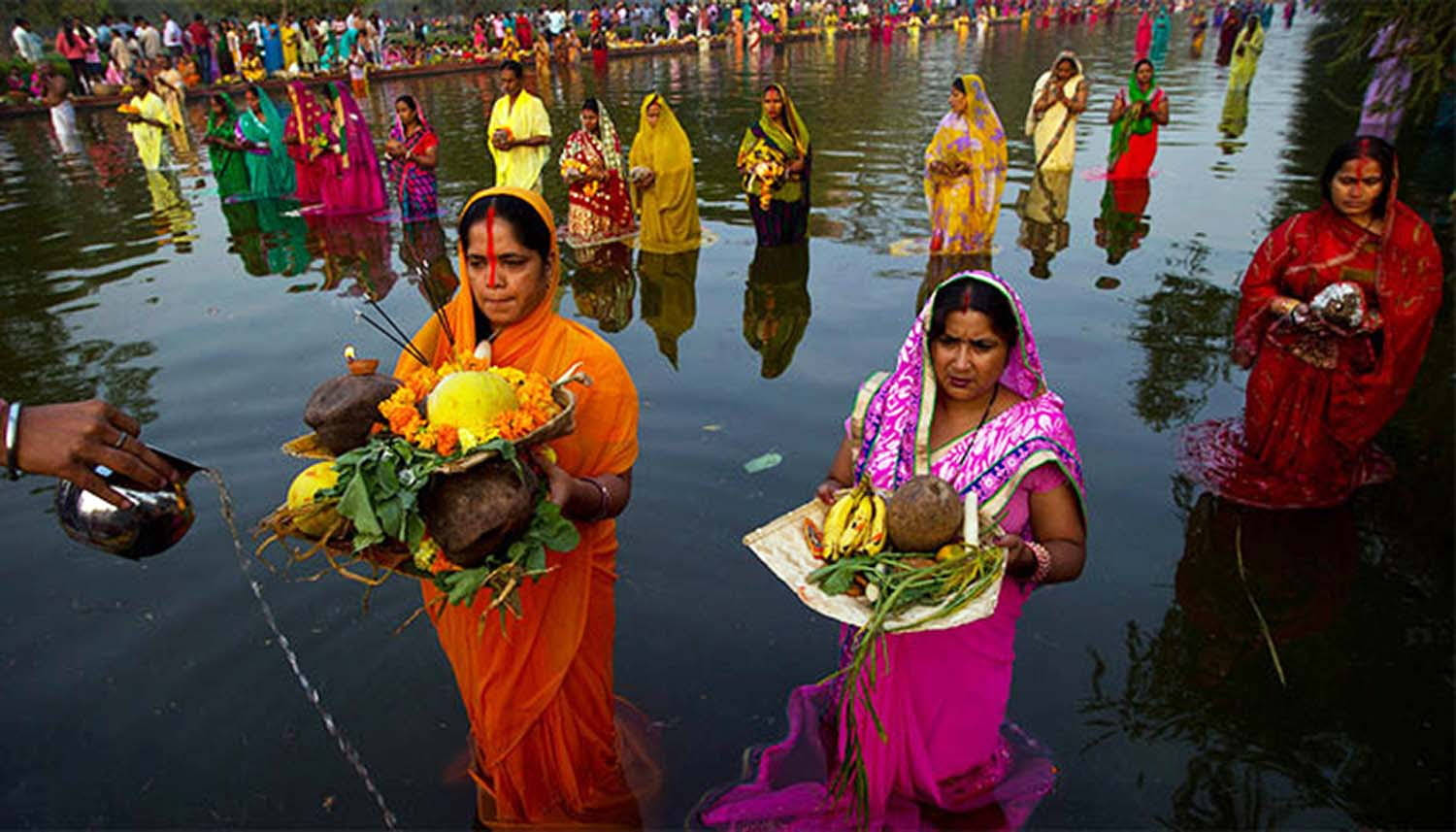 Lined Up Women In Ocean Chhath Puja Wallpaper