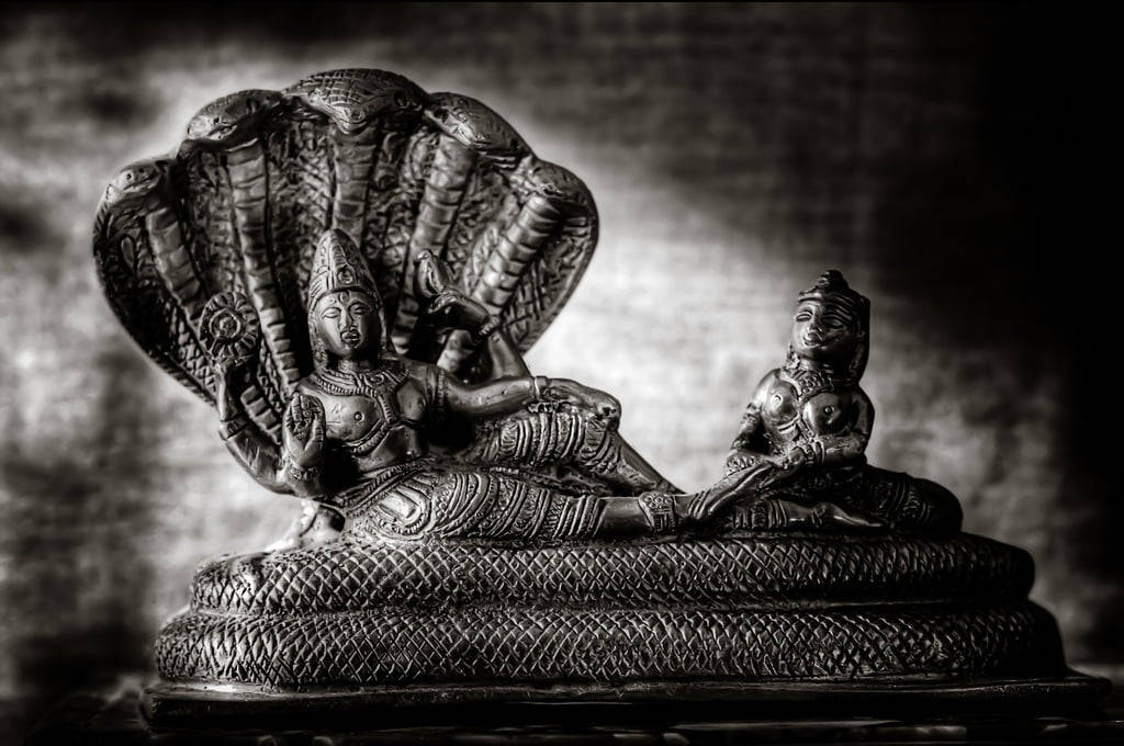 Majestic Black Figurine Of Lord Vishnu Wallpaper